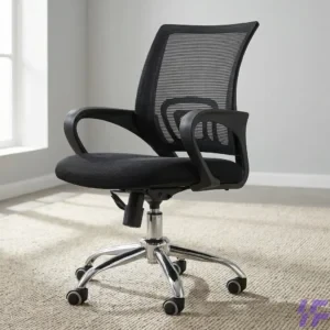 Ergonomic black mesh office chair with breathable high back, padded seat, fixed armrests, and chrome swivel base on wheels, styled on a neutral rug for a home office or professional workspace.