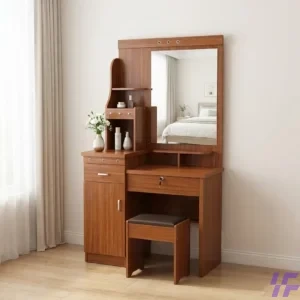 A modern elegant brown wooden dressing table with multiple drawers, shelves, a large mirror, and a matching cushioned stool, placed in a bright, minimalist bedroom with a bed and armchai