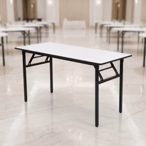 A clean white 1.8M Folding Banquet Table with sturdy black steel legs unfolded inside a modern corporate conference hall.