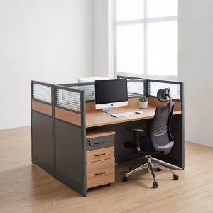 A sleek dark wood 2 Way Modular Office Workstation with a gray privacy divider and dual monitor setups inside a bright corporate workspace.