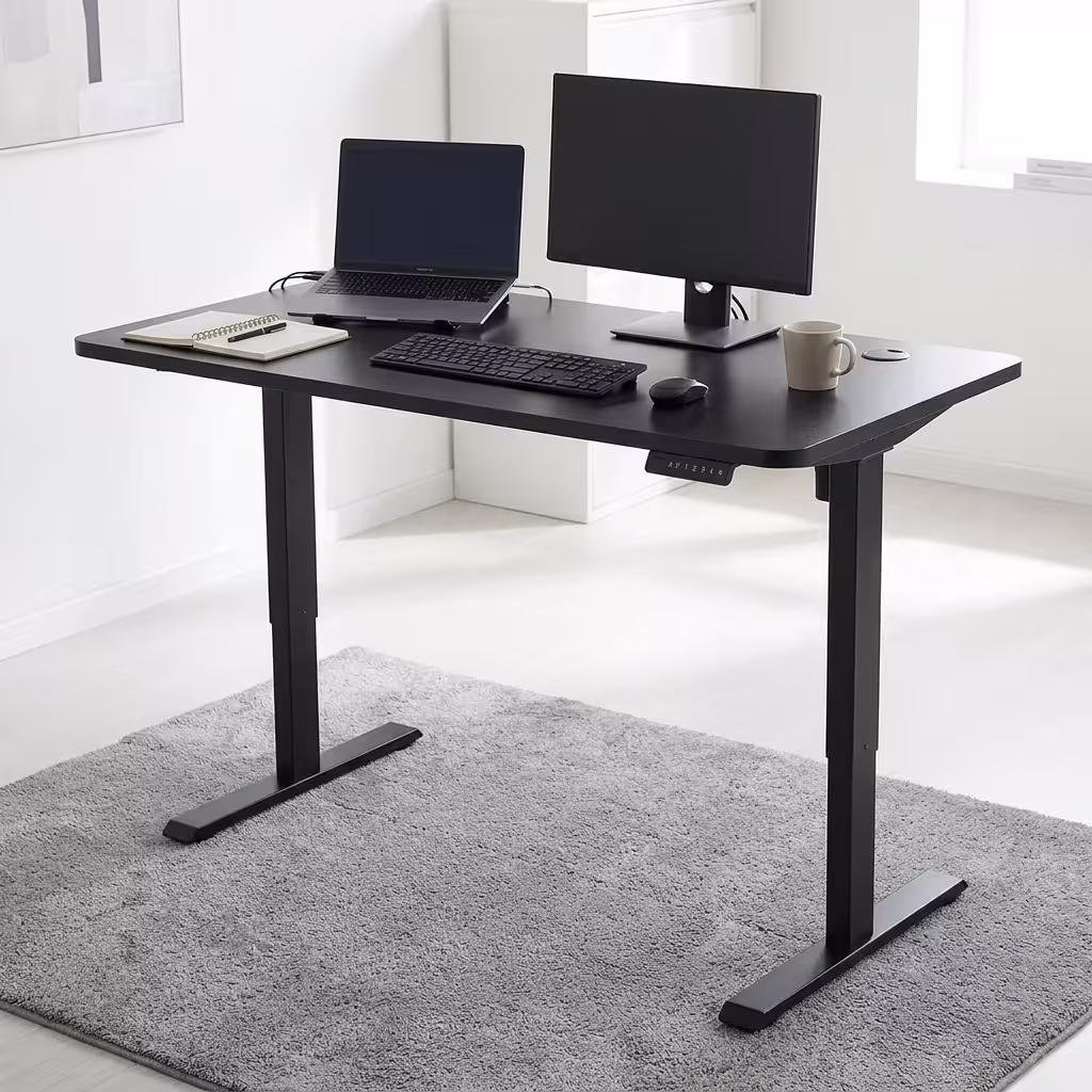 A modern dual-motor Smart Height Adjustable Desk holding two monitors elevated to standing height in a bright corporate office. A modern dual-motor Smart Height Adjustable Desk holding two monitors elevated to standing height in a bright corporate office.